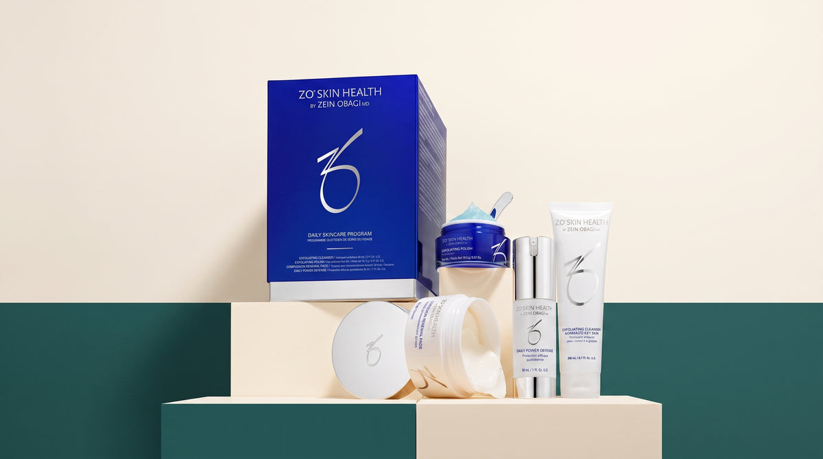 ZO Skin Health Daily Skincare Program box alongside individual ZO Skin Health jars and tubes, displayed on a cream and teal geometric backdrop.